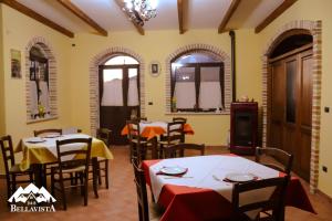 a restaurant with tables and chairs in a room at B&B Bellavista in Celano