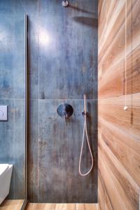 a shower in a bathroom with a metal wall at Politia in Ioannina +52 photos