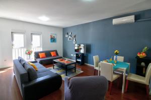 a living room with a couch and a table at Bonki apartment private free parking in Mokošica