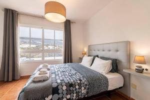 a bedroom with a bed with a large window at Casa Manuela in Callao Salvaje +54 photos