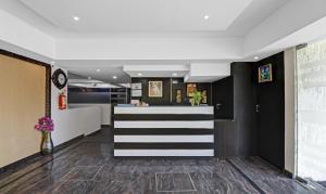 a lobby with a black and white striped counter at Treebo Trend JJ Residency in Bangalore