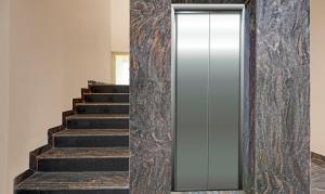 a mirrored wall with a mirror next to a staircase at Treebo JJ Residency in Bengaluru