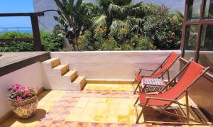 two chairs and a vase sitting on a balcony at Maison de la Lagune in Oualidia