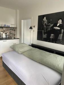 a bed in a room with a black and white picture at Appartement No 5 in Weimar