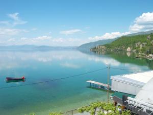 a view of a lake with a boat in the water at Apartment Polkaposki Trpejca in Trpejca
