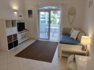 a small living room with a bed and a table at Family Dominicus Apartment - Bayahibe in Bayahibe