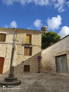 a building with a clock tower on top of it at Cerro del Alcazar in Baeza