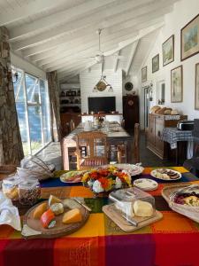 a table with plates of food on top of it at Posada La Serena in Tandil