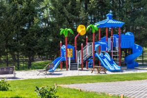a playground with a slide in a park at Domki Aqua Holiday in Pobierowo