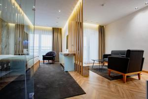 a hotel room with a bed and a desk at Ador Hotel in Prishtinë