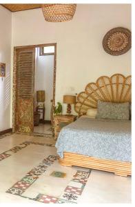 a bedroom with a bed and an open door at Sriyana Uluwatu in Uluwatu