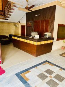 a lobby with a reception desk in a building at Hotel Mehran Multan in Multan