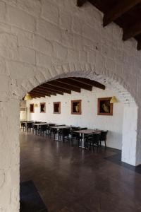 a room with tables and chairs in a stone wall at Costa Luvi Hotel Bodrum - All Inclusive in Gümbet