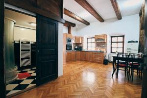 a kitchen with a table and a dining room at Kutná Hora Apartment in Kutná Hora