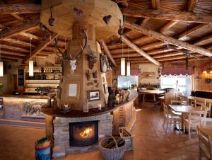 a living room with a fireplace in a restaurant at RESORT VALFORMICA in Asiago