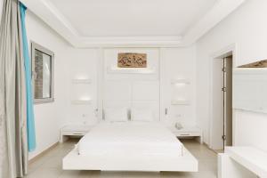 a white bedroom with a bed and white walls at Costa Luvi Hotel Bodrum - All Inclusive in Gümbet