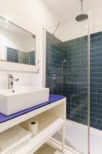 a bathroom with a sink and a shower at Costa Luvi Hotel Bodrum - All Inclusive in Gümbet