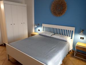 a bedroom with a large bed with a blue wall at Franita in Rossano