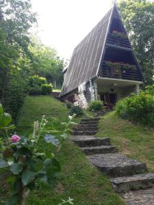 a house with a slate roof with stairs leading to it at KUĆA ZA ODMOR DRAGONFLY RIVER HOUSE on KORANA near PLITVICE and MREŽNICA in Barilović