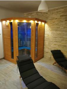 a room with two black chairs and a window at Villa Bosna Near Dubrovnik very beautiful Villa entirely privatized swimming pool, jacuzzi, sauna, billiard, ping-pong in Ivanica