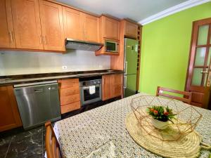 a kitchen with a table with a vase of flowers on it at CasaTranquila in Los Llanos de Aridane