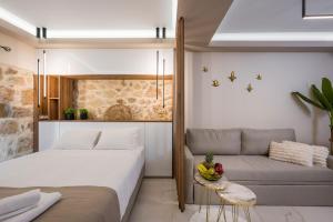 a bedroom with a bed and a couch with a bowl of fruit at La vista de Pablo in Chania Town +16 photos