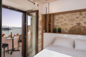 a bedroom with a bed and a view of the ocean at La vista de Pablo in Chania Town