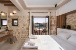 a bedroom with a large bed and a table with chairs at La vista de Pablo in Chania Town
