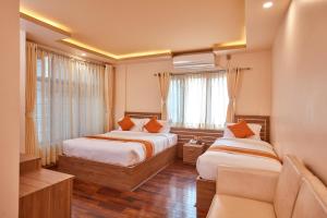 una camera d'albergo con due letti e un divano di The Samrat Palace - Luxury Hotel in Kathmandu a Kathmandu