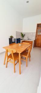 a wooden table and two benches in a room at HOME VILLA in Pabean Buleleng