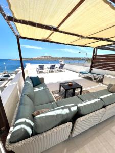 a couch sitting under a large umbrella on a boat at Villa Michael in St Paul's Bay