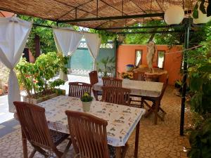 a patio with a table and chairs and a table at Salento - A Casa di Lilli in Porto Cesareo