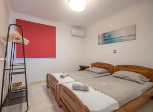 a bedroom with two beds and a ladder in it at Ancora Beach House by "elite" in Tsilivi