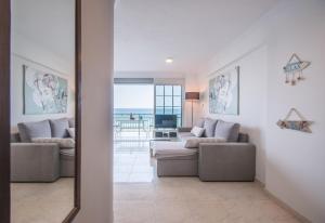 a living room with a couch and a table at Ancora Beach House by "elite" in Tsilivi