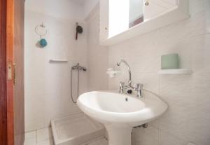 a white bathroom with a sink and a shower at Ancora Beach House by "elite" in Tsilivi +33 photos