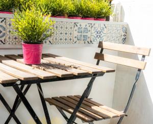 a wooden table with potted plants on a balcony at Vive Valencia con playa y metro cerca in Valencia