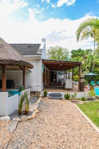 a backyard with a patio and a house at Khashamongo B & B in Somerset West