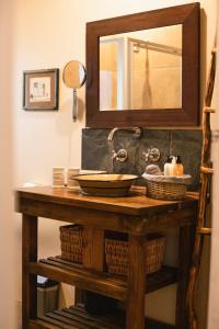 a bathroom vanity with a mirror and a sink at Khashamongo B & B in Somerset West