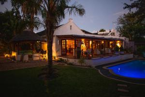 a house with a swimming pool in front of it at Khashamongo B & B in Somerset West