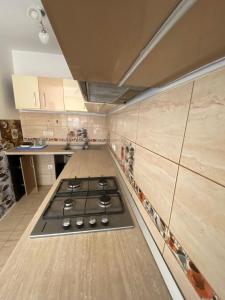 a kitchen with a stove top in the middle of it at Apartament de lux in Costinesti