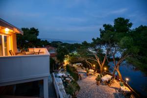 a view of a balcony of a building at night at Apartments Stermasi in Saplunara