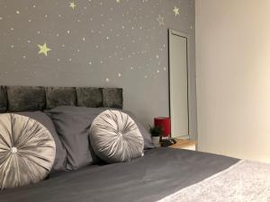 a bedroom with a bed with stars on the wall at 08 St Andrews in Lytham St Annes