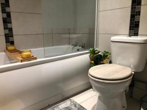 a bathroom with a toilet and a bath tub at 08 St Andrews in Lytham St Annes