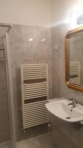 a white bathroom with a sink and a mirror at La Terrazza in Spoleto