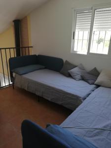 A bed or beds in a room at LA ANTIGUA CASA DEL ASTRONOMO Casa Rural