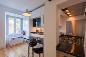 a kitchen with a black counter top in a room at FLH São Jorge Castle Flat in Lisbon