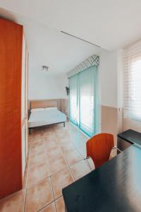 a room with a table and a bed in a room at Casa adosada con piscina privada in Alfaz del Pi