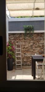 a ladder sitting next to a stone wall with a plant at LISA HOUSE in Catania