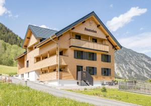 a large wooden building with a mountain in the background at Haus Amatschon in Brand