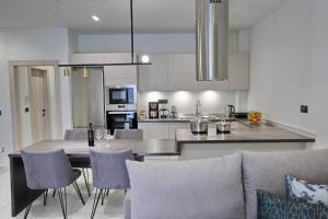 a kitchen and living room with a table and chairs at Ioanna's Suite in Nafplio